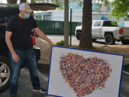 Artist Adam Pinsley showing his art "I 'Heart' Decatur"