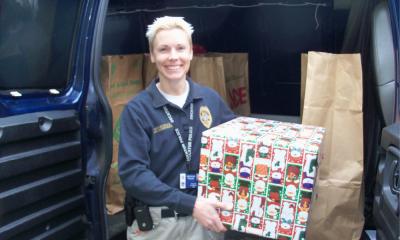 Season of giving - officer holding wrapped gift