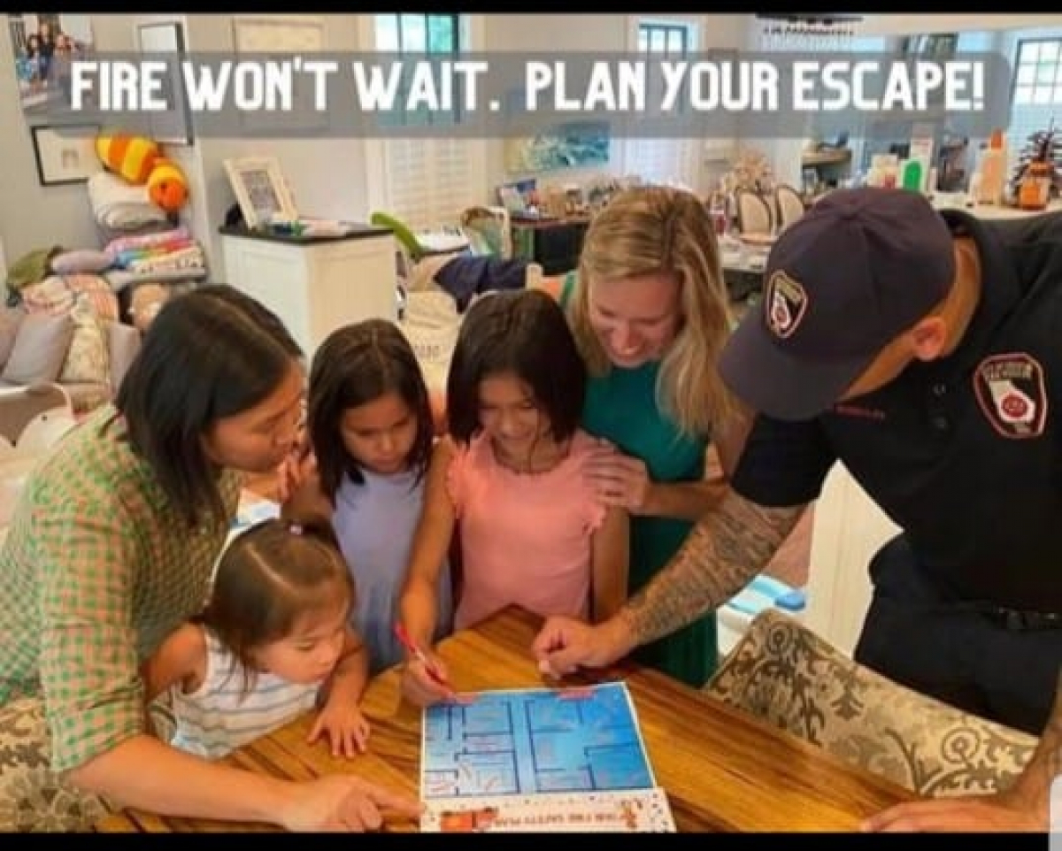 family studying a fire safety escape plan