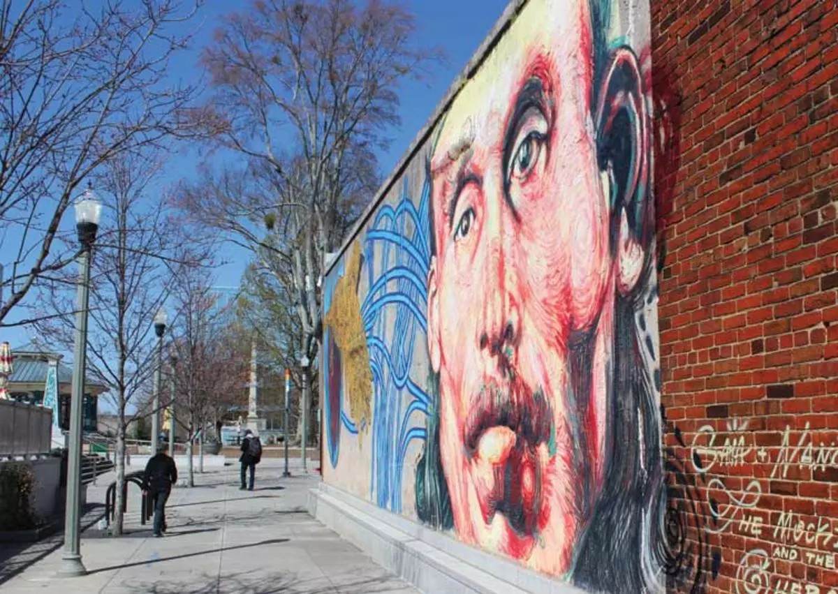 Mural on wall along sidewalk